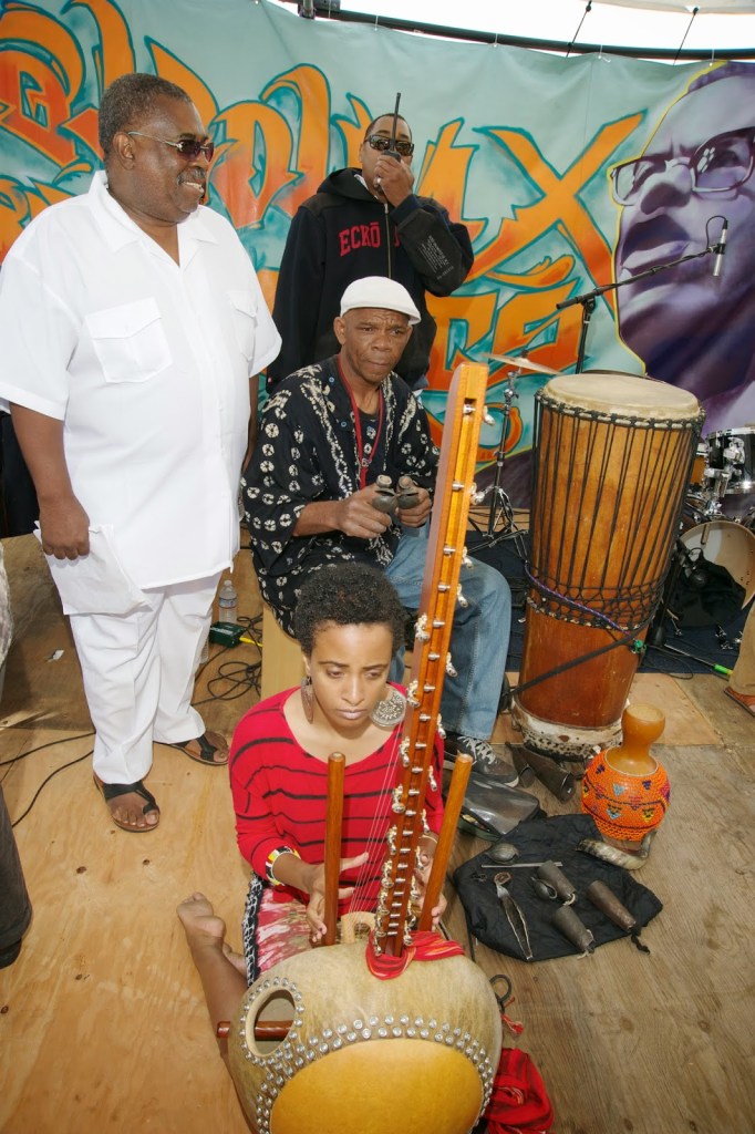 X and Tacuma King and girl with african instrument